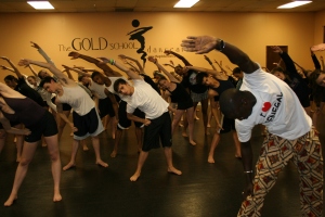 Aziz leads students in warm-up excercises.